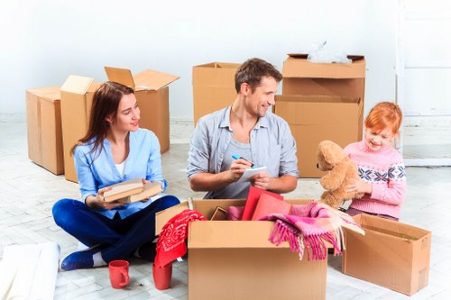 Trained movers carrying furniture carefully through a property