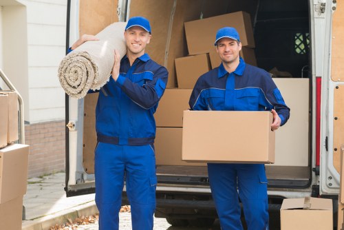 A Wandsworth moving helper preparing items beside a van
