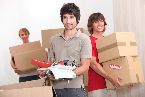 Professional movers handling office furniture and IT items