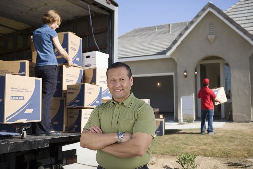 Professional movers handling furniture during a flat relocation